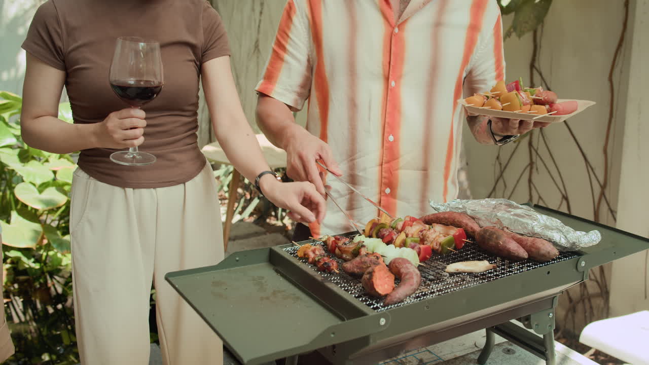 Anonymous Girlfriend and Boyfriend Having Barbecue with Wine at Backyard