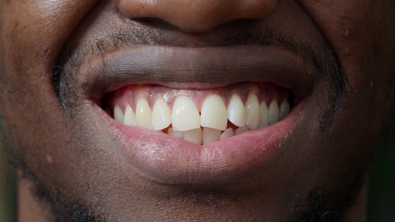 Macro shot of male model showing candid smile on camera