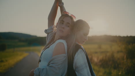 Women-With-Hands-Raised-Standing-Back-To-Back