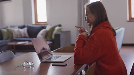 woman having a video chat on her laptop at home