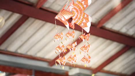 a vibrant hanging mobile sways gently