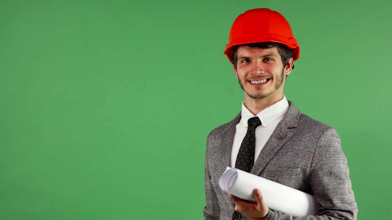 Cheerful handsome engineer holding copy space on his hand