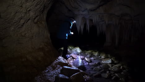 person exploring an ice cave with a headlamp
