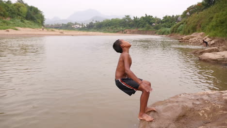 boy jumping into river