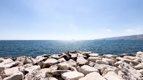 bright day over calm sea and rocky shoreline in sorento, italy