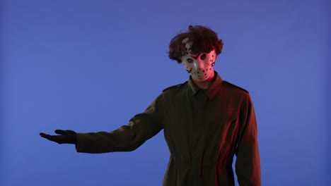 person wearing jason voorhees hockey mask on a blue background