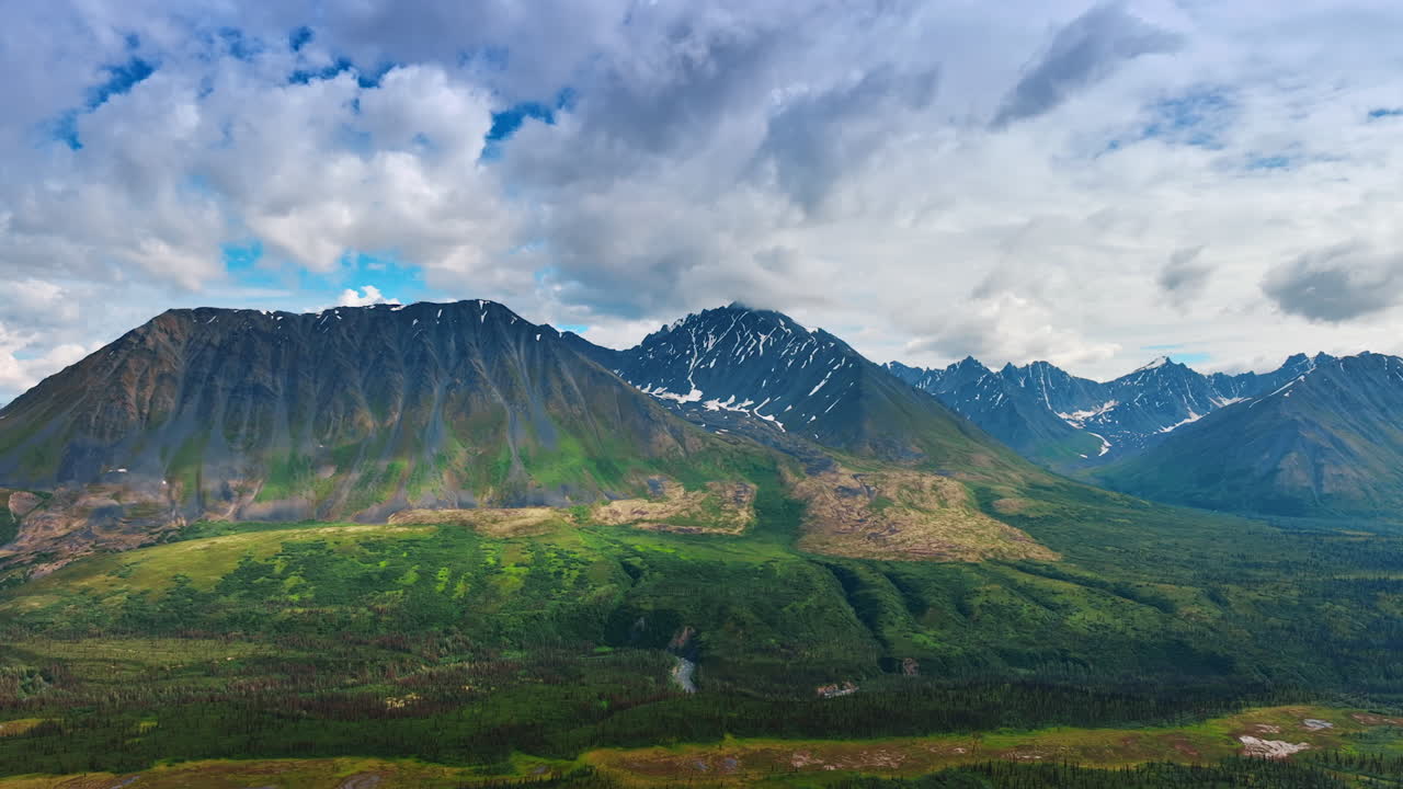 Discover Alaska stunning views. Breathtaking Alaska landscape features green valleys, majestic mountains, and a dynamic sky
