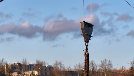 chains hanging on a hook that hangs from a crane, aerial view