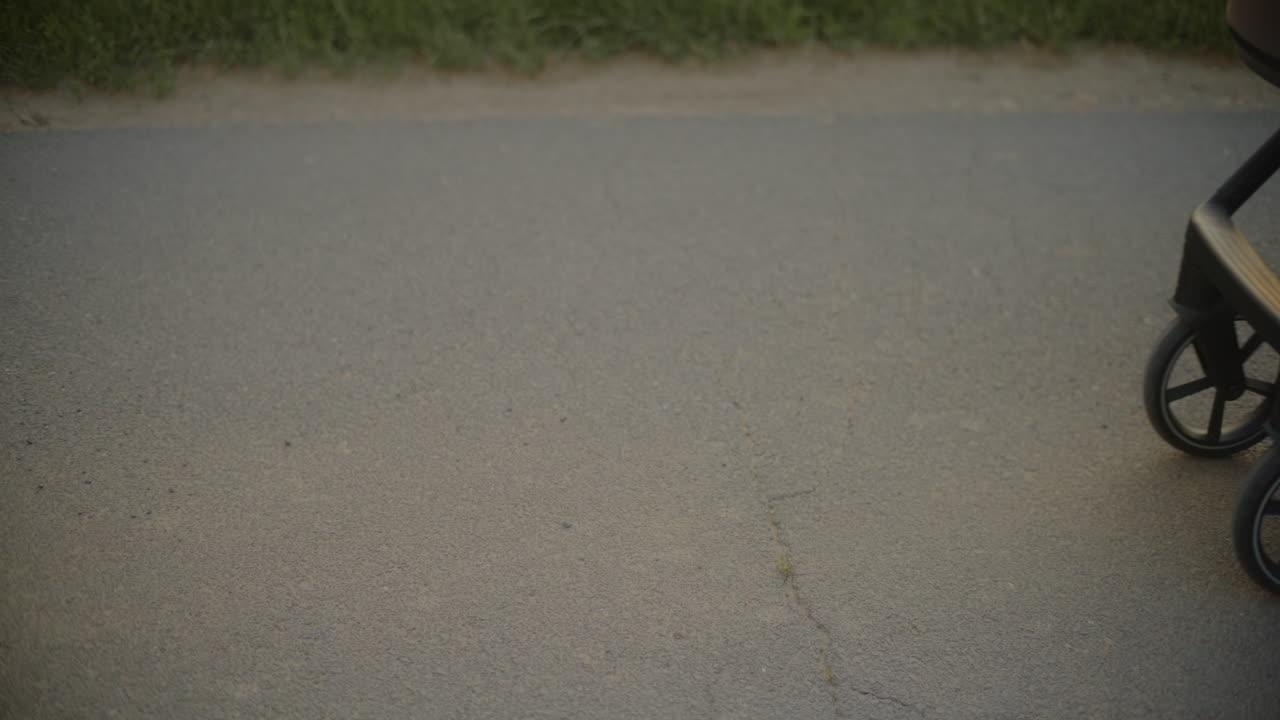 CloseUp of Baby Stroller Wheels on Asphalt