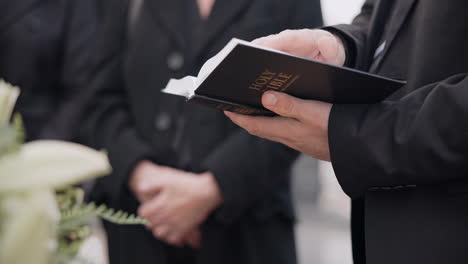 Bible,-funeral-and-hands-reading-of-a-priest