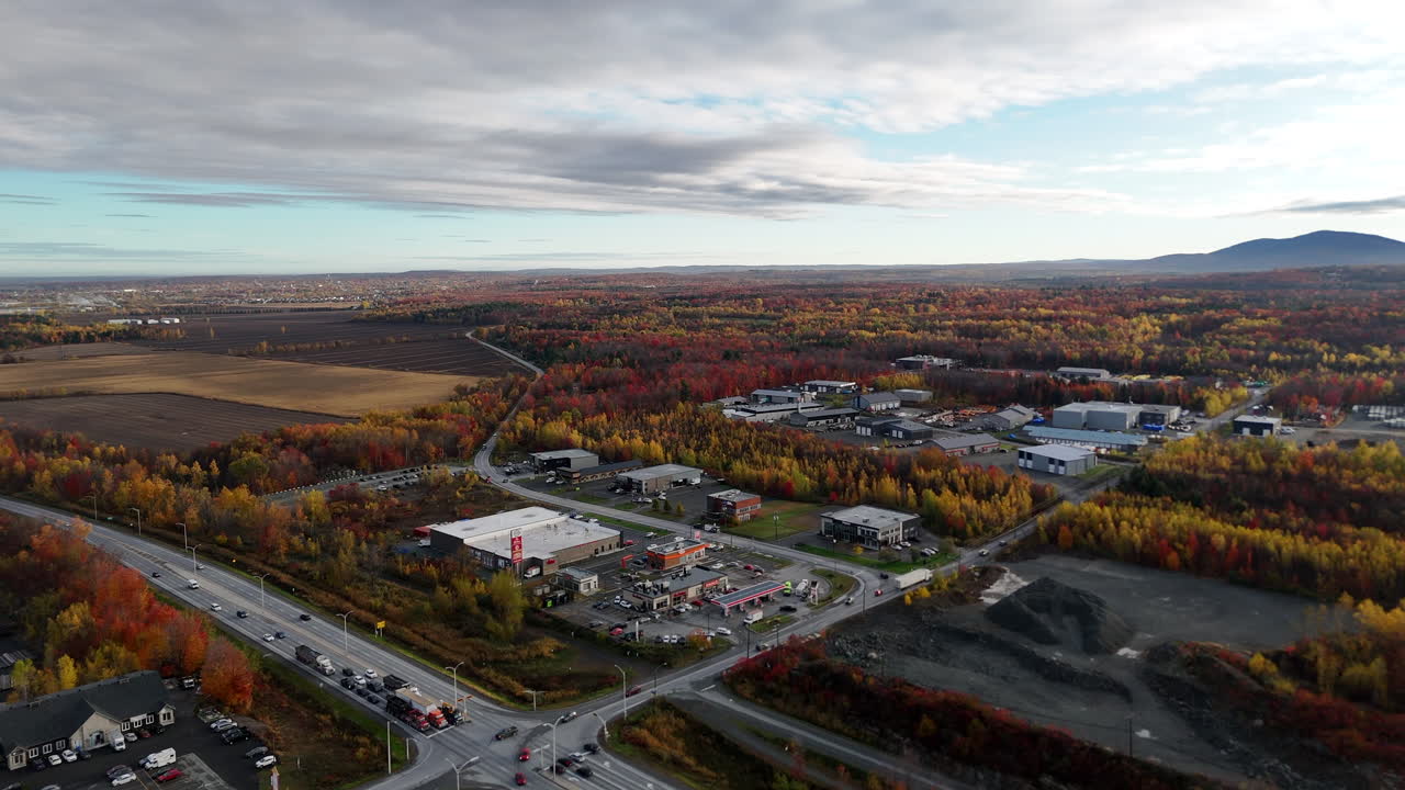 Aerial footage over Highway 10 and Route 139 interchange in Granby, Quebec, showing busy traffic and the commercial zone near exit 68 during autumn