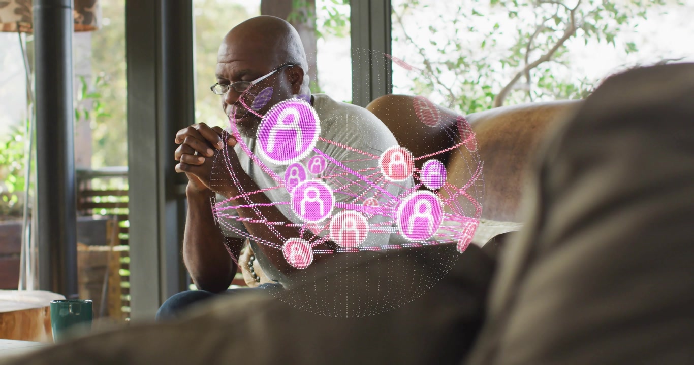 Senior man leaning on sofa examining holographic sphere materializing mapping data connections