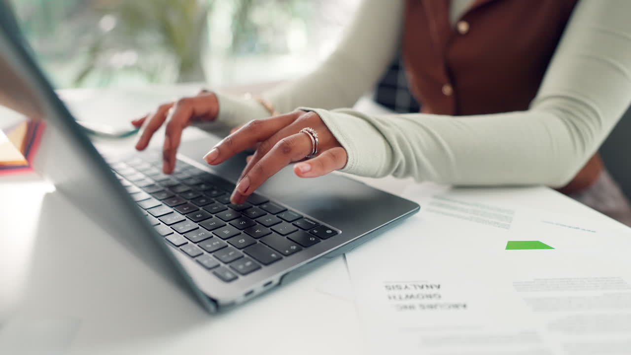 Close Up of Person's Hands Typing on Laptop Keyboard