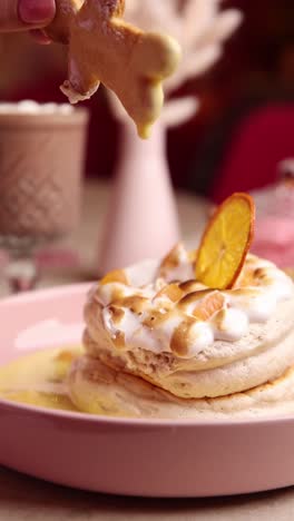 plato de postre rosa con galleta de pan de jengibre y merengue