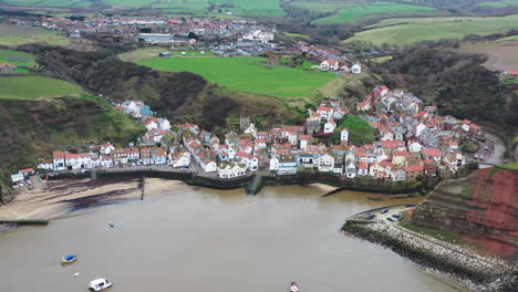 staithes aerial footage slowly moving backwards and up revealing harbour then stationary