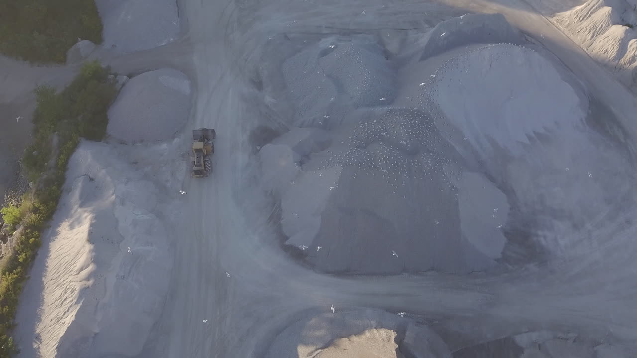 Heavy Machinery At Work Moving In The Sand Reclamation Area In Kingsville, Ontario, Canada On A Bright Morning - aerial shot