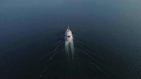 slow aerial tilt down shot of a ferry boat on lake geneva near vevey, switzerland