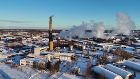 industrial buildings emitting smoke in the middle of the small town in easter europe