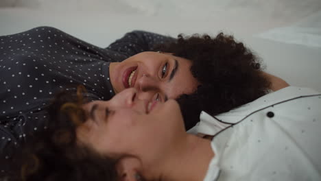 Happy-couple-talking-on-bed