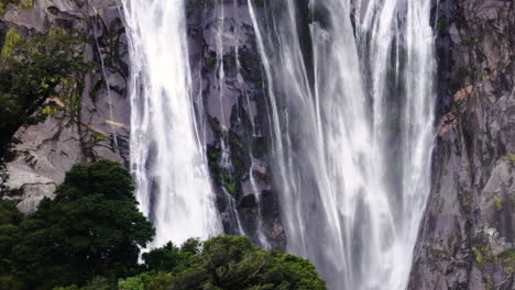 powerful waterfall in milford sound, new zealand - lady bowen falls