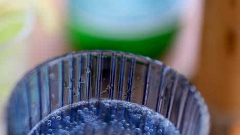 detailed view of bubbles forming on the rim of a glass, showcasing texture and clarity.
