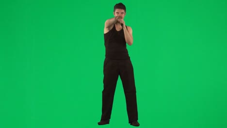 Man-singing-with-a-microphone-against-green-screen