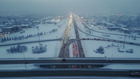 drone shot straight down freeway or highway traffic during rush hour on a foggy and winter evening