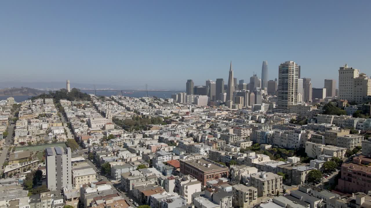 Captivating almost-still drone shot of San Francisco's downtown with Coit Tower, slight rotation adding a soft parallax effect