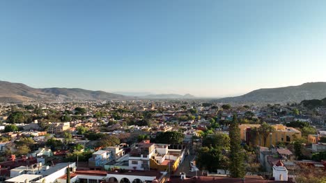 Aerial-View-of-Oaxaca-Mexico-Cityscape-Skyline,-Homes-and-Streets-Under-Clear-Blue-Sky
