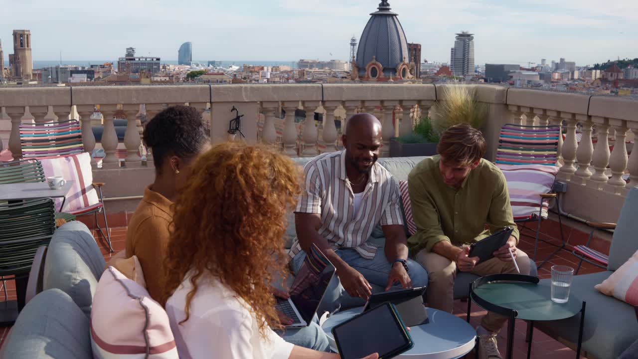 Group of people working together on a rooftop in the city