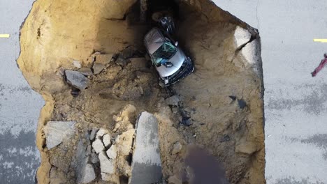 large sinkhole swallows cars on busy street