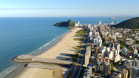 aerial view of caiobá beach, city buildings, and breakwater in paraná, brazil