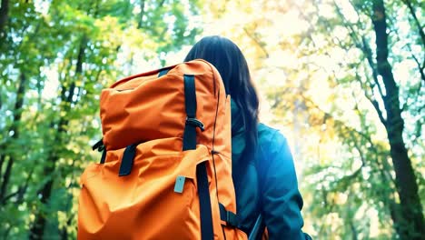 woman hiking through a forest with a backpack