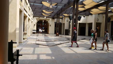 three people walking through a covered market