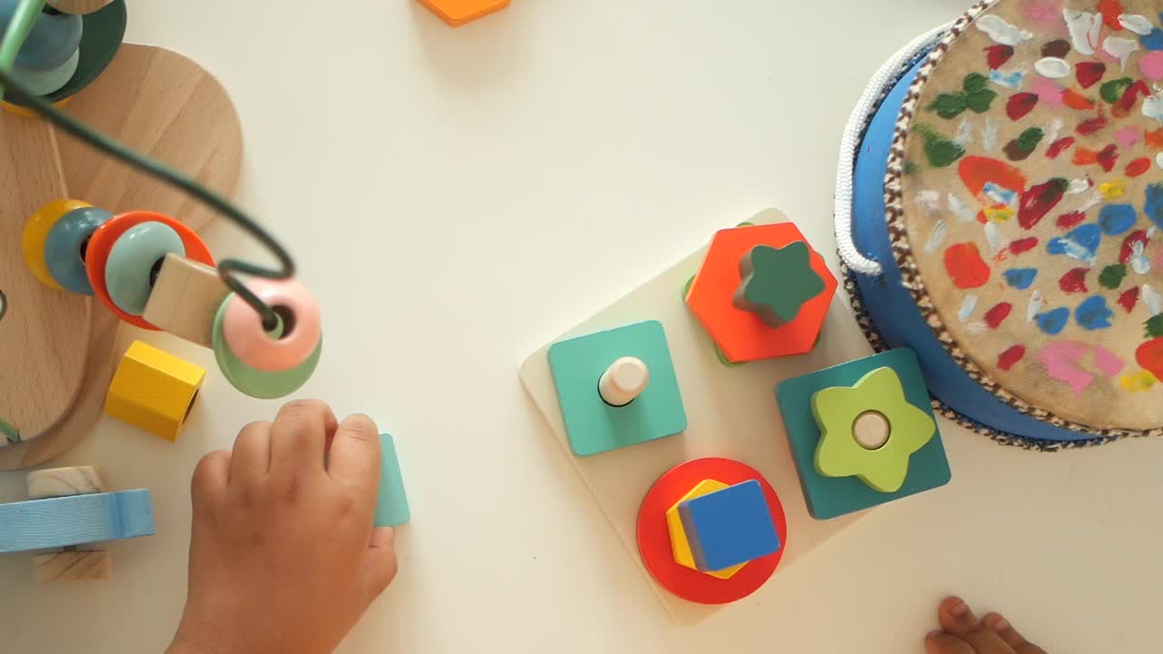 Child playing with wooden educational toys