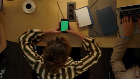 Creative-people-brainstorming-in-office.-Woman-sitting-at-table-with-phone.