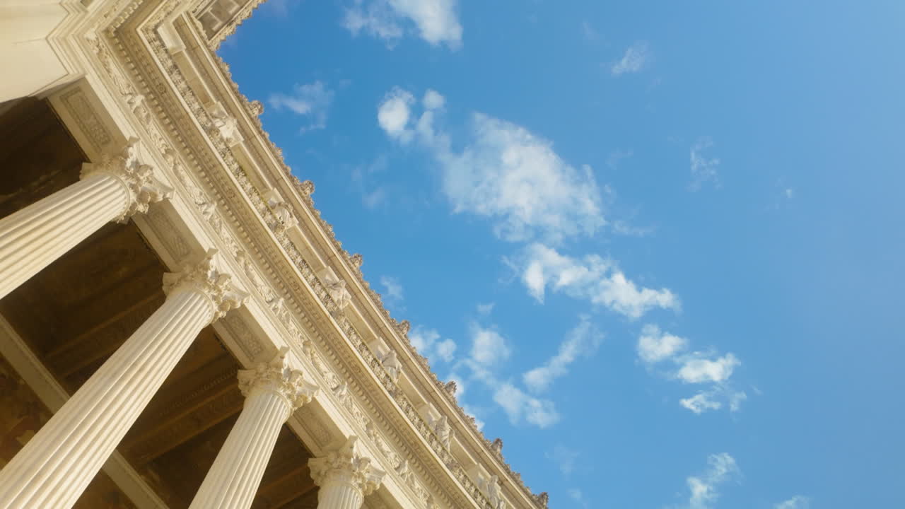 View of Roman architecture with detailed columns under vivid sky, classical city scene.