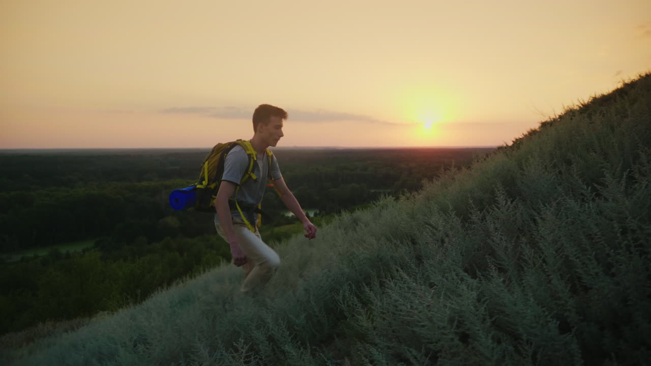 The Guy The Teenager With A Backpack Climbs Up The Mountain At Sunset Active Way Of Life Since Youth