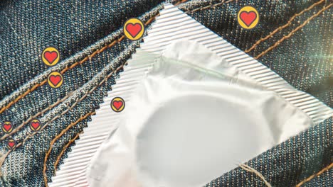 Animation-of-heart-icons-over-condom-in-denim-trousers