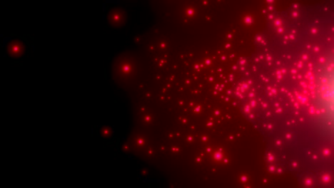 pequeñas partículas rojas y estrellas en fondo oscuro