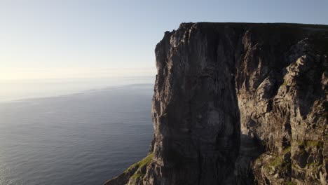 aerial shot of highrise ryten rocky peak in beautiful seascape view, kvalvika beach