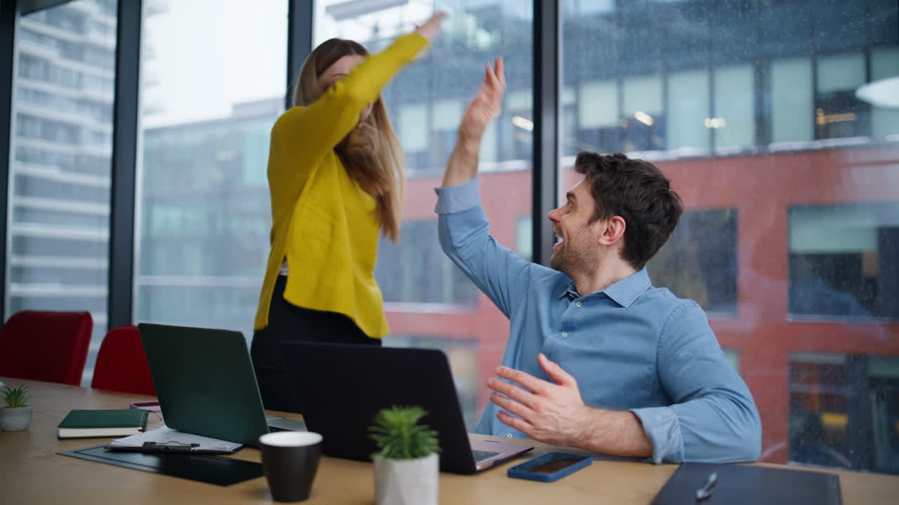 Happy coworkers giving five collaborating on business project. Smiling woman man