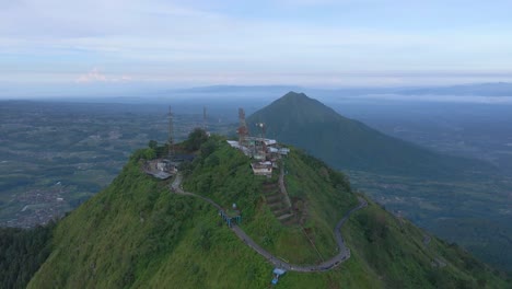 5G-GSM-internet-towers-on-mountain-top-in-Indonesia,-aerial-panoramic-view