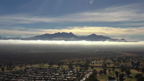 foggy day southern arizona green valley sahuarita. santa rita mountains in distance. aerial forward wide shot.