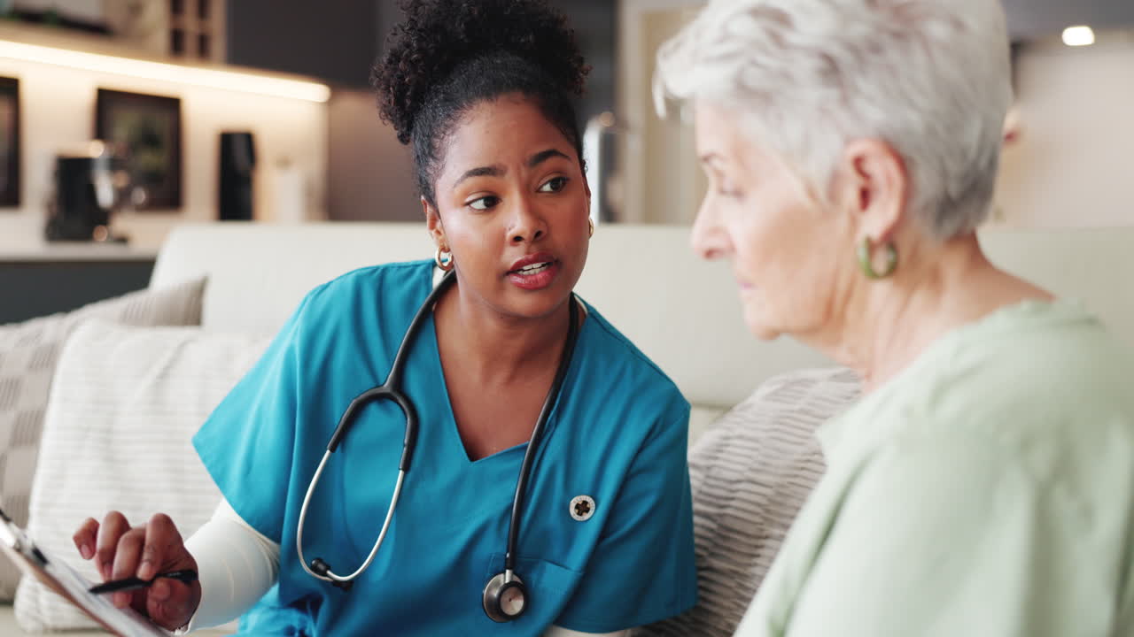 Nurse Explaining Medical Information to Senior Woman During Home Visit