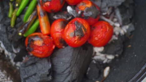 slow motion close up of tomatoes and chillies on bbq with smooth pan