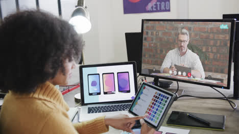 African-american-businesswoman-on-video-call-with-caucasian-male-colleague-on-screen