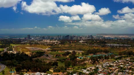 aerial pan of golf course and balboa park with san diego, the bay and coronado bridge in the distance.  northern of 2