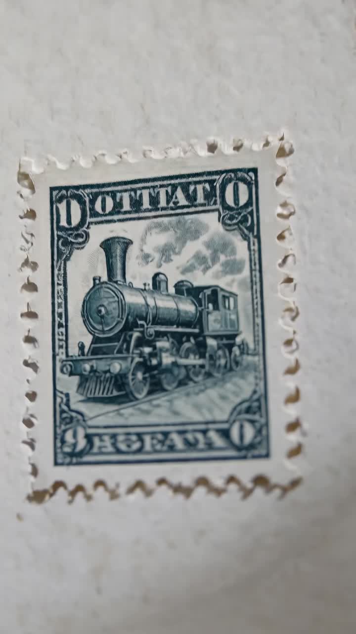 Close-up angled shot of a vintage train stamp with intricate details, resembling an old film style