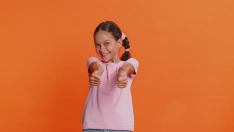 happy preteen child girl kid looking approvingly at camera showing thumbs up like positive sign